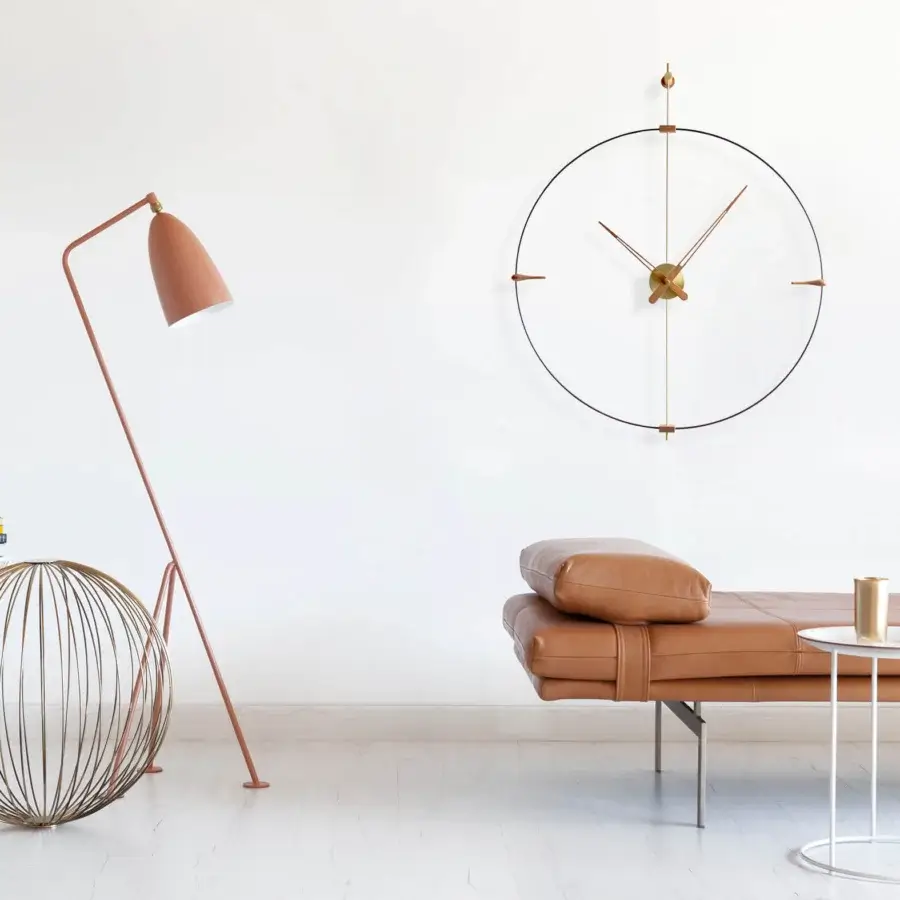 Refined Nomon Mini Bilbao wall clock with a muted copper finish and sleek metal construction offering a satin sheen