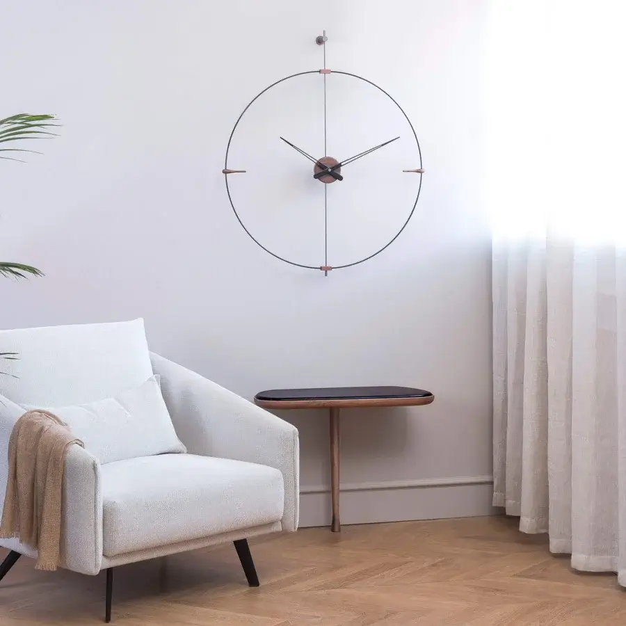 Distinguished Nomon Mini Bilbao wall clock with a sleek metal frame and warm copper-toned finish embodies calm geometry