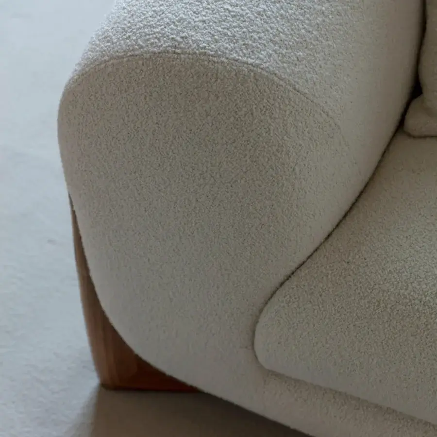 Distinguished Porada Softbay sofa with gently curved form upholstered in textured bouclage cotton, linen and wool with satin Canaletta walnut end-feet
