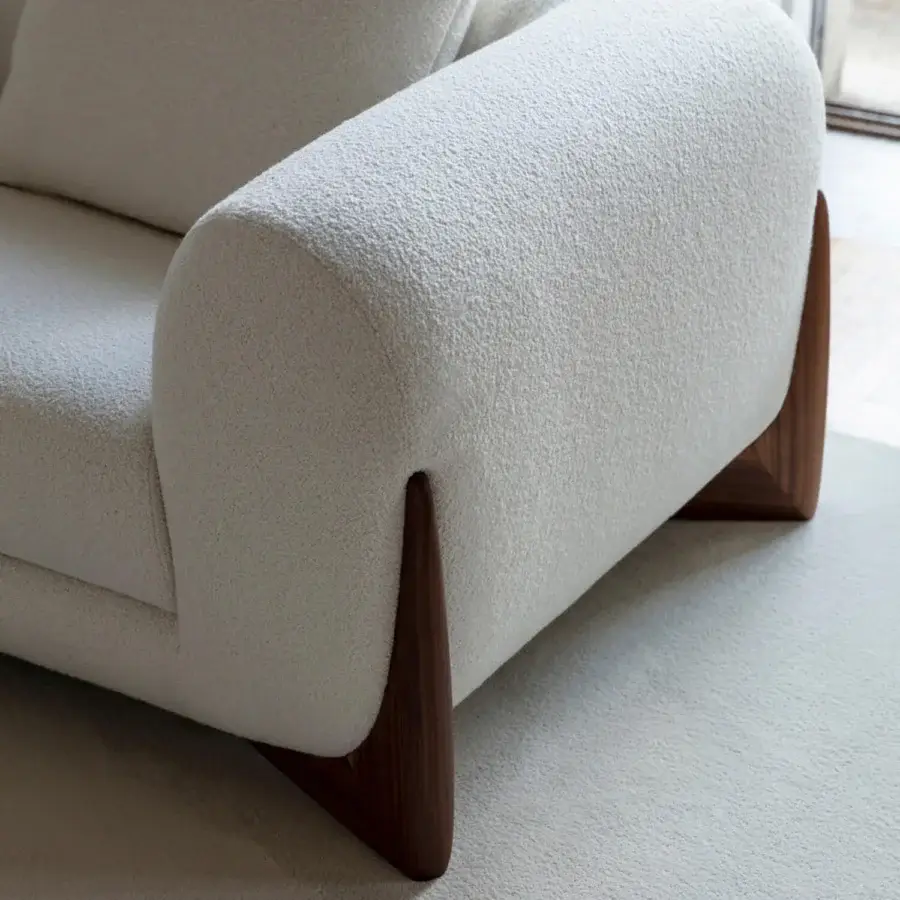 Distinguished Porada Softbay sofa with enveloping curves and plush bouclage upholstery in off-white, built with satin Canaletta walnut end-feet
