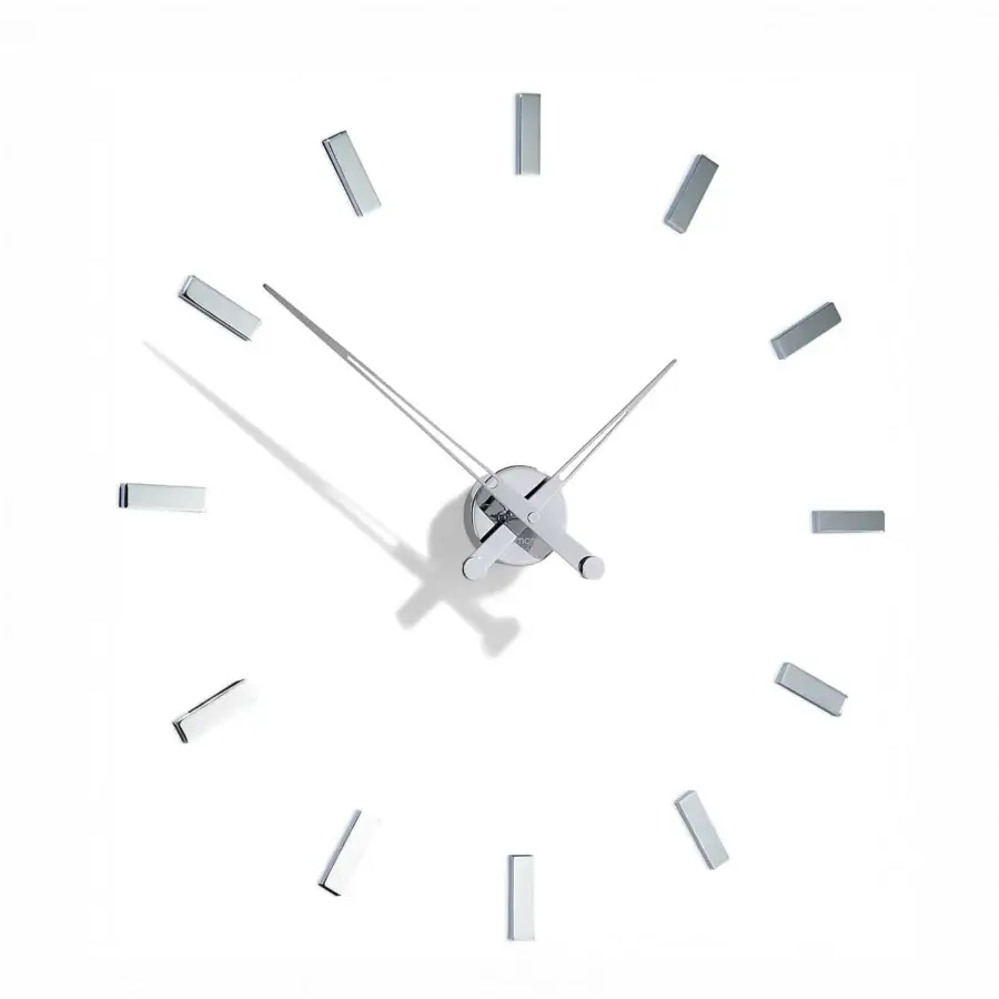 Avant-garde Nomon Tacón wall clock with a white face and slender metallic hands crafted in metal and smooth synthetic material