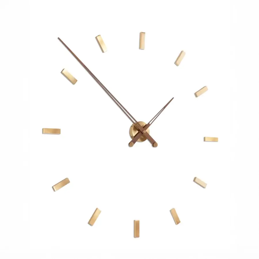 Captivating Nomon Tacón wall clock with a white face and bold gold-toned metallic hands and hour markers
