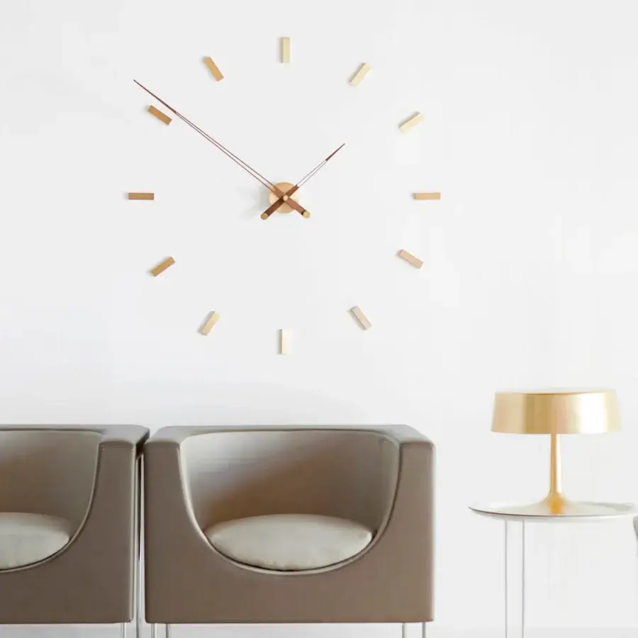 Exclusive Nomon Tacón wall clock crafted in metal with a satin finish and muted gold-toned hands