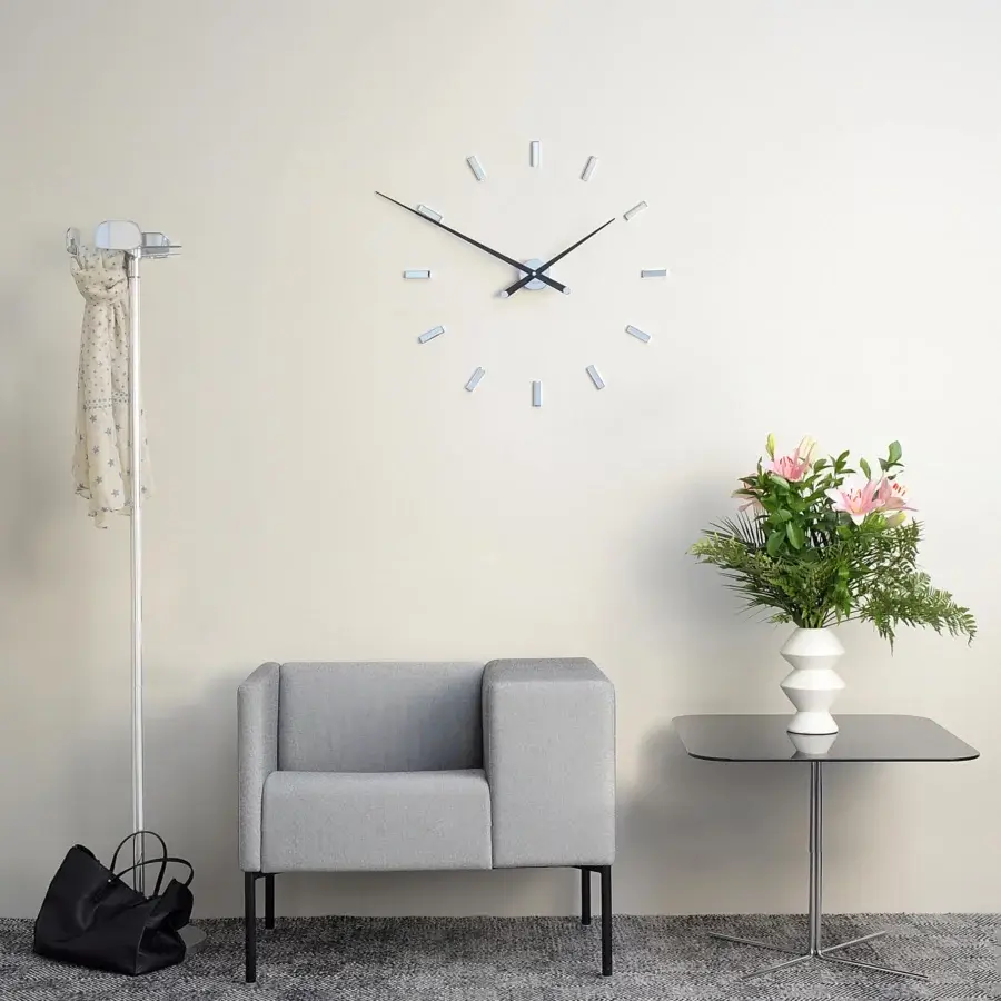Avant-garde Nomon Tacón wall clock crafted with a light gray face and contrasting dark hands in a smooth matte finish