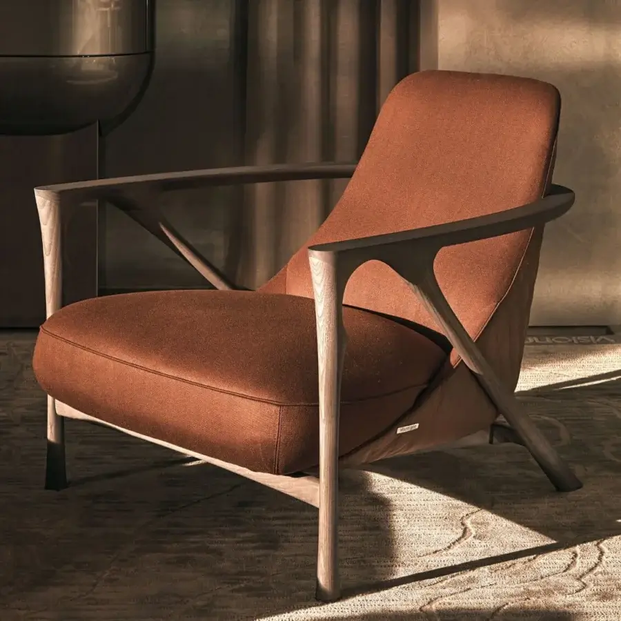 Distinguished Visionnaire Alya lounge chair with sculpted solid ash wood and reddish-brown textured textile upholstery with satin finish