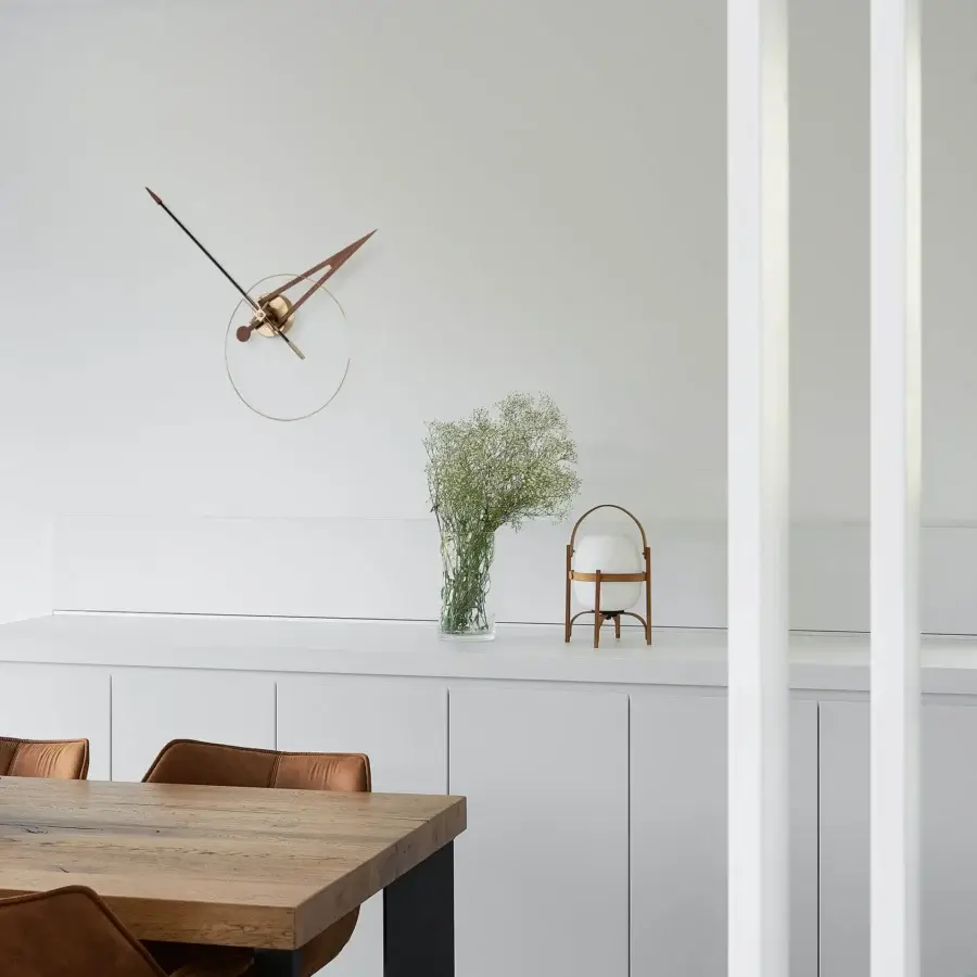 Superior Nomon Cris wall clock crafted in bronze tone with a sleek metallic ring and fiberglass minute hand