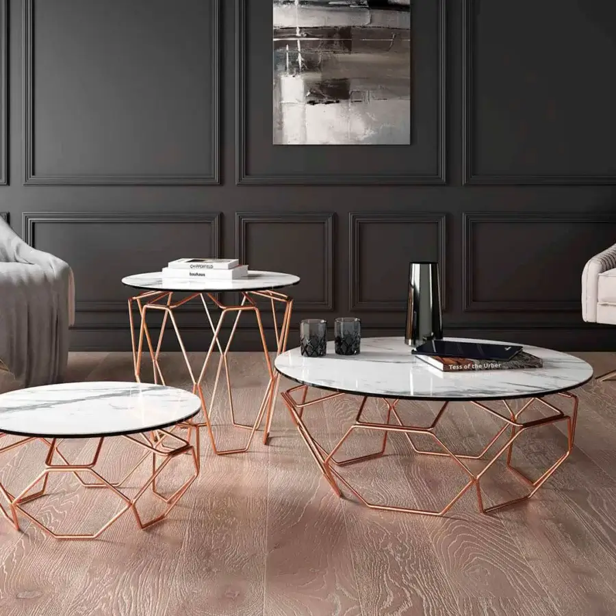 Distinguished Naos Hive coffee table with a white ceramic top and rose-gold toned painted steel architecturally sculpted base