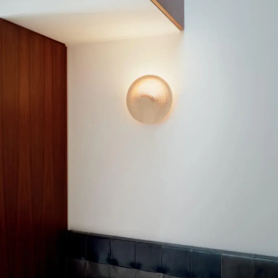 Distinctive Luceplan Illan wall lamp crafted in layered wood and die-cast aluminum with a warm, pale gold finish