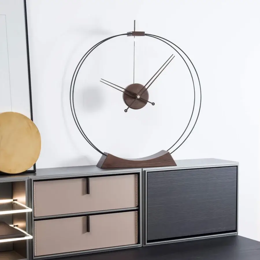 Elegant Nomon Aire table clock in warm walnut wood with sleek brass details and dark brown finish