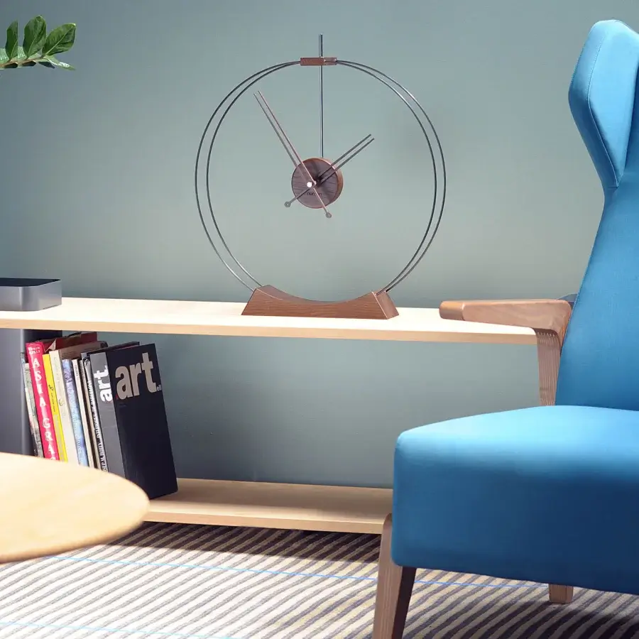 Superior Nomon Aire table clock in warm walnut wood with satin brass accents and a dark circular face