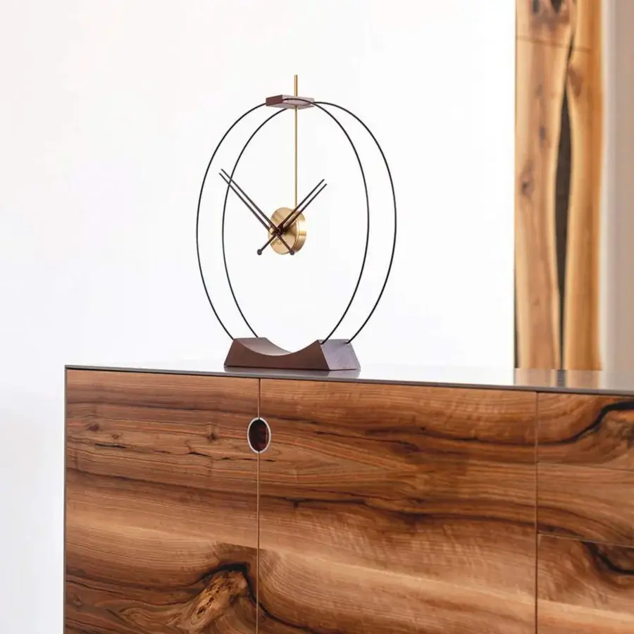 Distinguished Nomon Aire table clock crafted in walnut wood with brass-accented details and a muted bronze metal frame