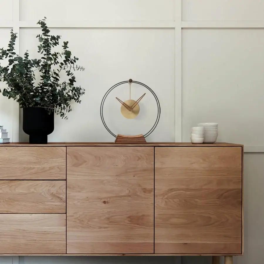 Elegant Nomon Mini Aire table clock with double black fiberglass, walnut components and delicate brass details