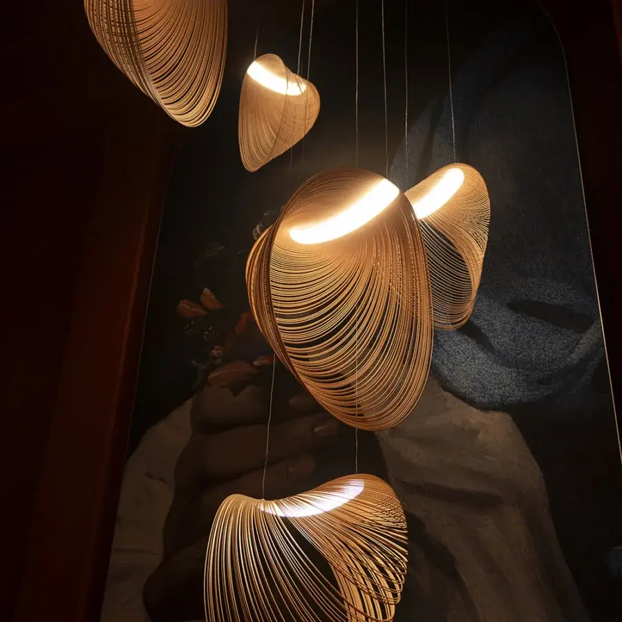 Elegant Luceplan Illan suspension lamp crafted in layered plywood with a satin finish and warm glow