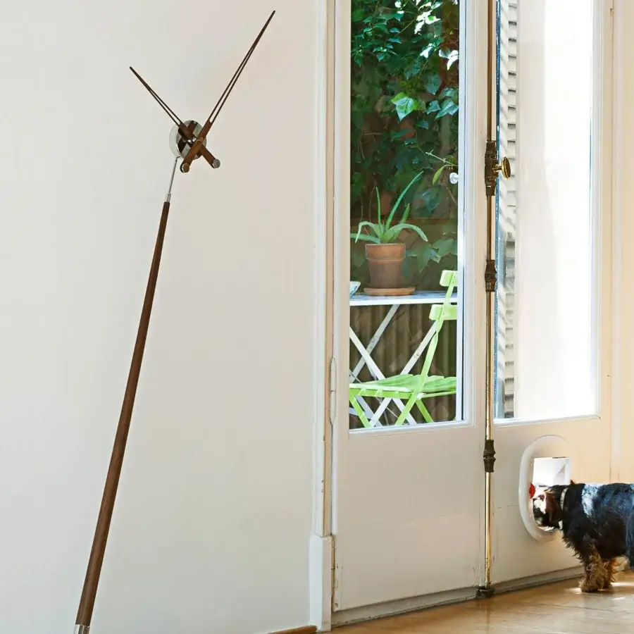 Avant-garde Nomon Pisa Floor Clock with a dynamic architectural silhouette crafted in solid wood and polished metal with a warm brown finish