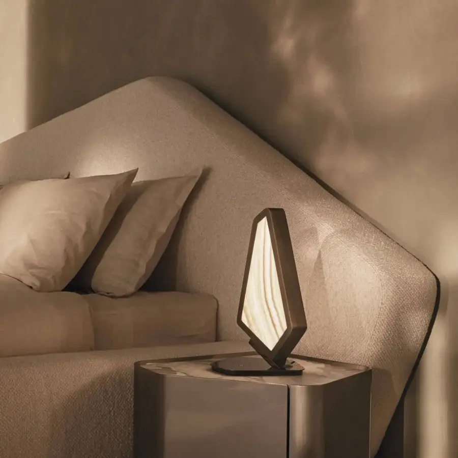 Superior Visionnaire Neolito nightstand with angled wooden structure and “leather”-finish marble top in metallic bronze lacquer