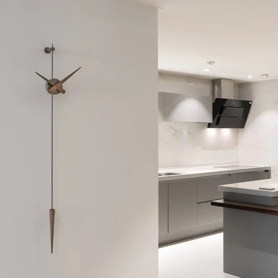 Superior Nomon Punto y Coma clock crafted in medium brown wood with a smooth satin finish