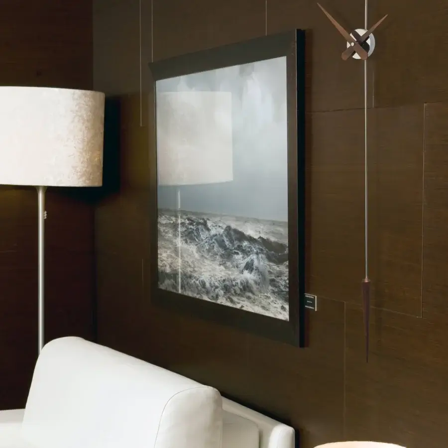 Refined Nomon Punto y Coma clock crafted in wood with a satin finish and dark-toned metal delivering chromatic contrast