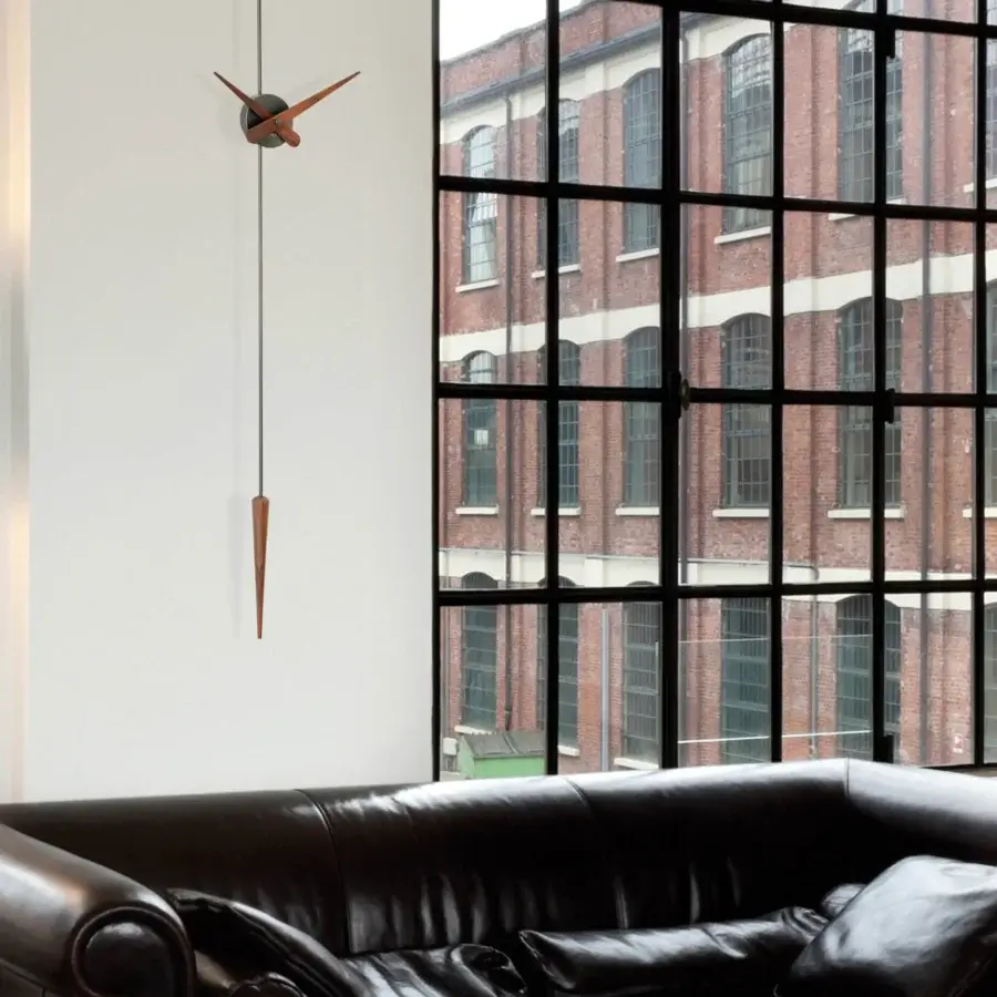 Distinguished Nomon Punto y Coma clock crafted in wood with dark metal, exhibiting an asymmetrical design and smooth satin finish