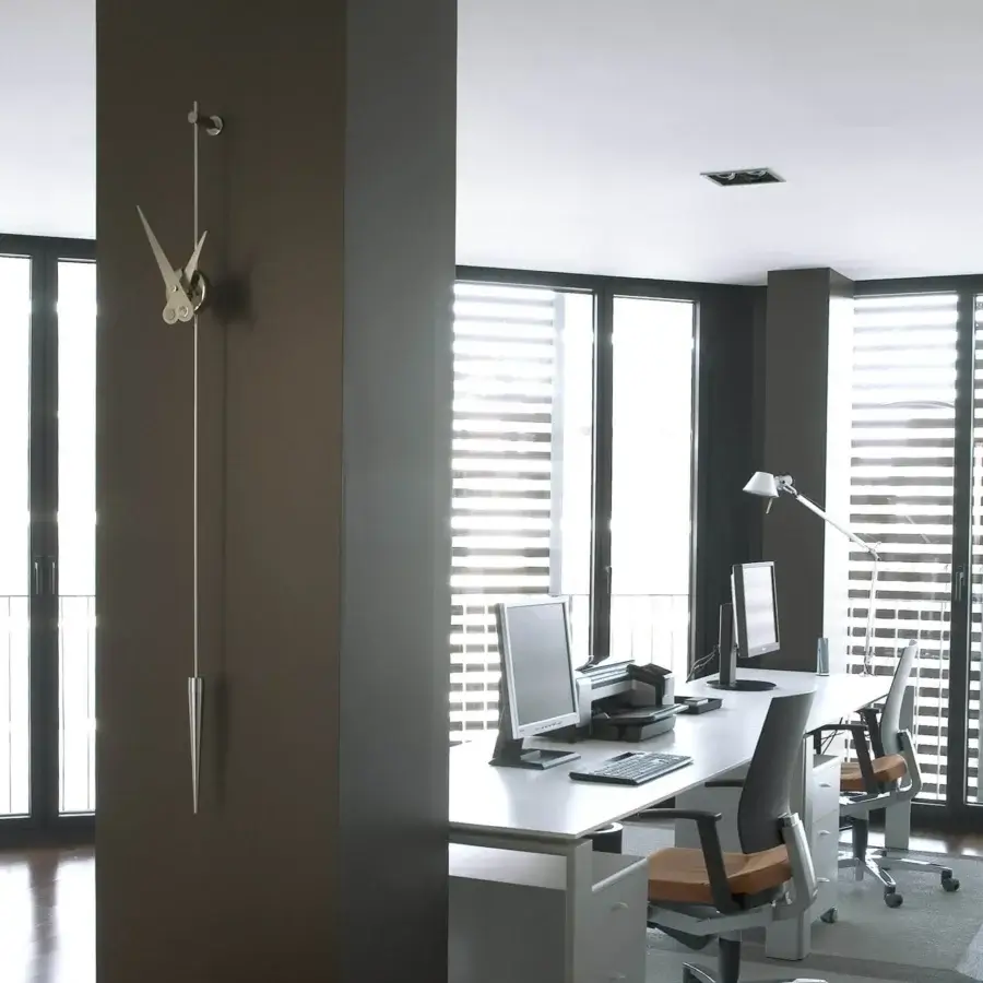 Exceptional Nomon Punto y Coma clock in dark-toned wood with satin metal components and a smooth matte finish
