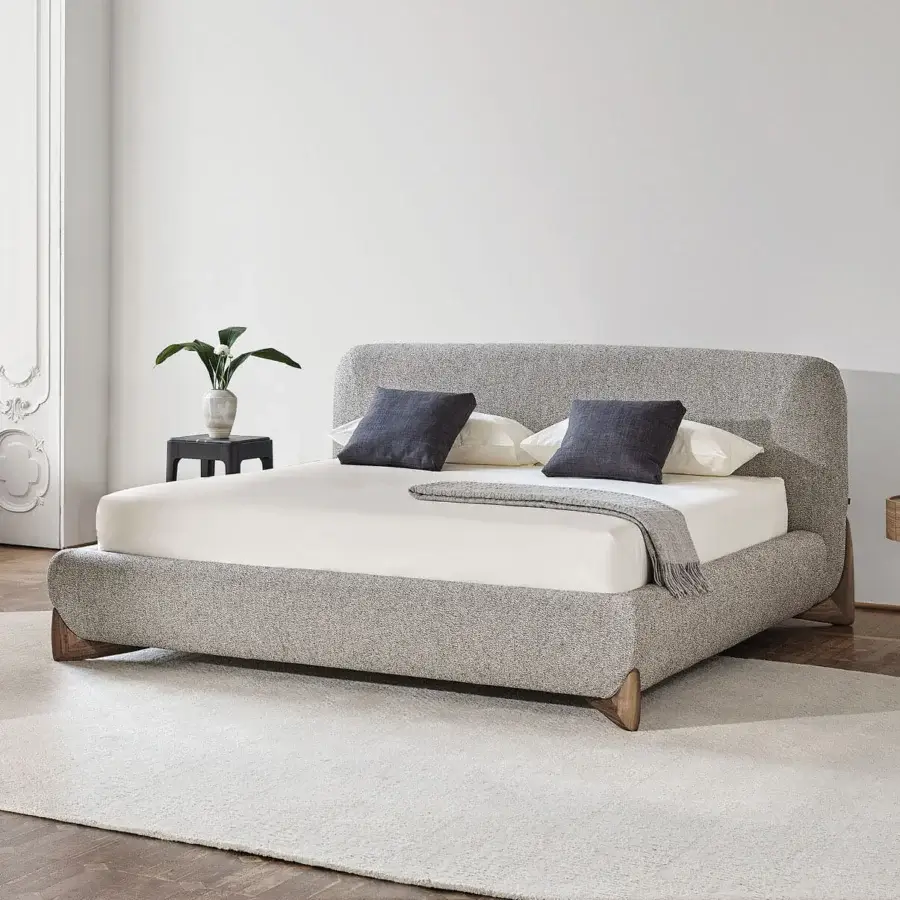 Lavish Softbay Bed Max bed upholstered in light gray textured textile with a gracefully wrapping canaletto walnut frame