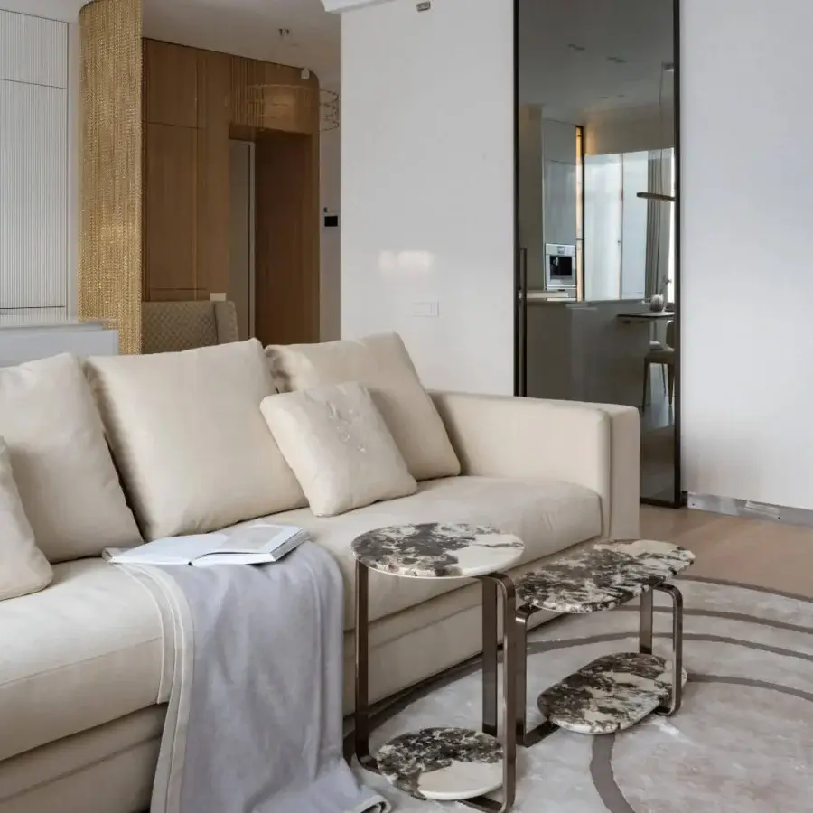 Elegant Visionnaire Button coffee and side table with overlapping hand-polished marble tops and curved stainless steel base