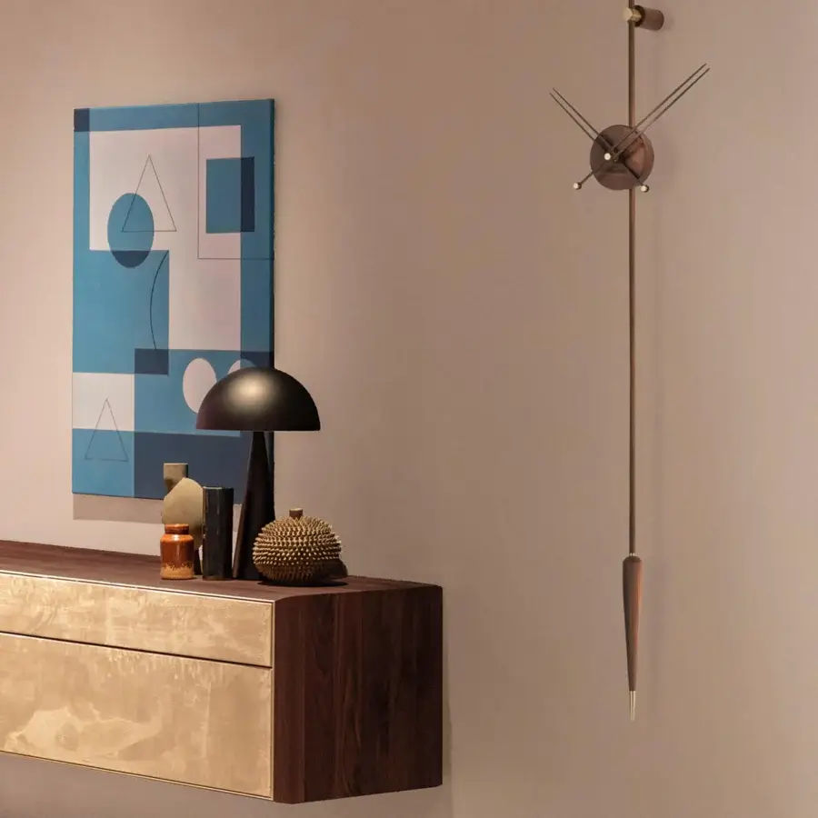 Superior Nomon Punto y Coma Premium clock crafted in walnut wood with brass details and muted bronze metallic finish