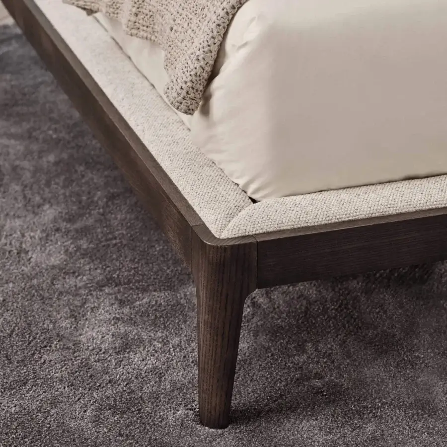 Elegant Porada Ziggy Bed Soft with a solid canaletto walnut frame and light beige fully upholstered headboard in satin finish