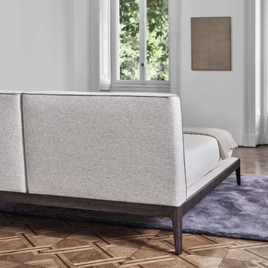 Refined Porada Ziggy Bed Soft with a solid canaletto walnut frame and fully upholstered light beige textile cover crafted with polyurethane foam padding