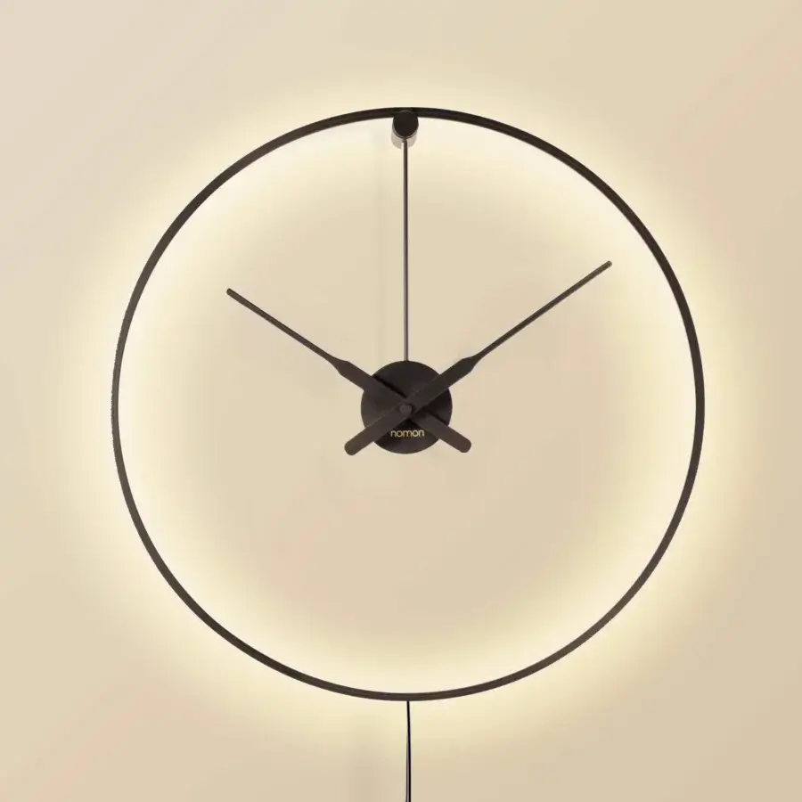 Distinguished Nomon Ombra clock lamp with a black anodized aluminum ring and warm white ambient light emission