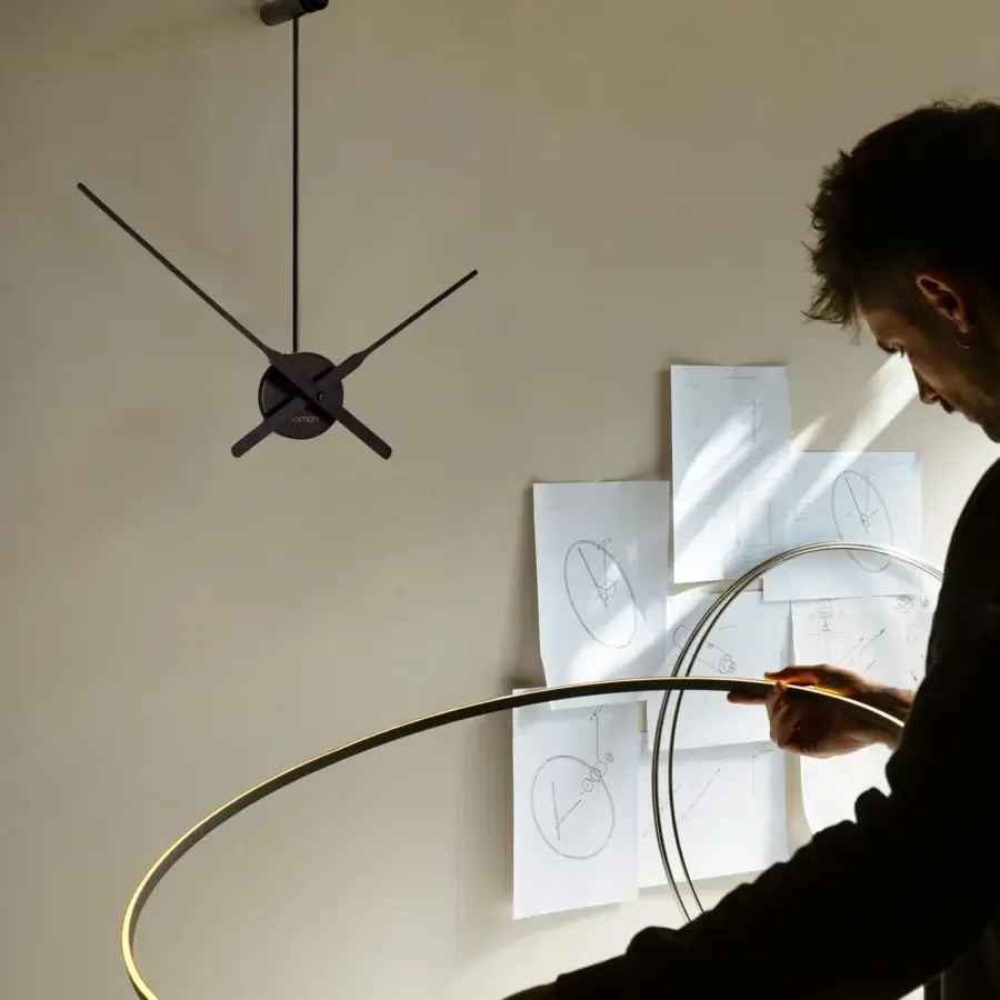 Elegant Nomon Ombra clock lamp crafted in black anodized aluminum with a warm diffused glow