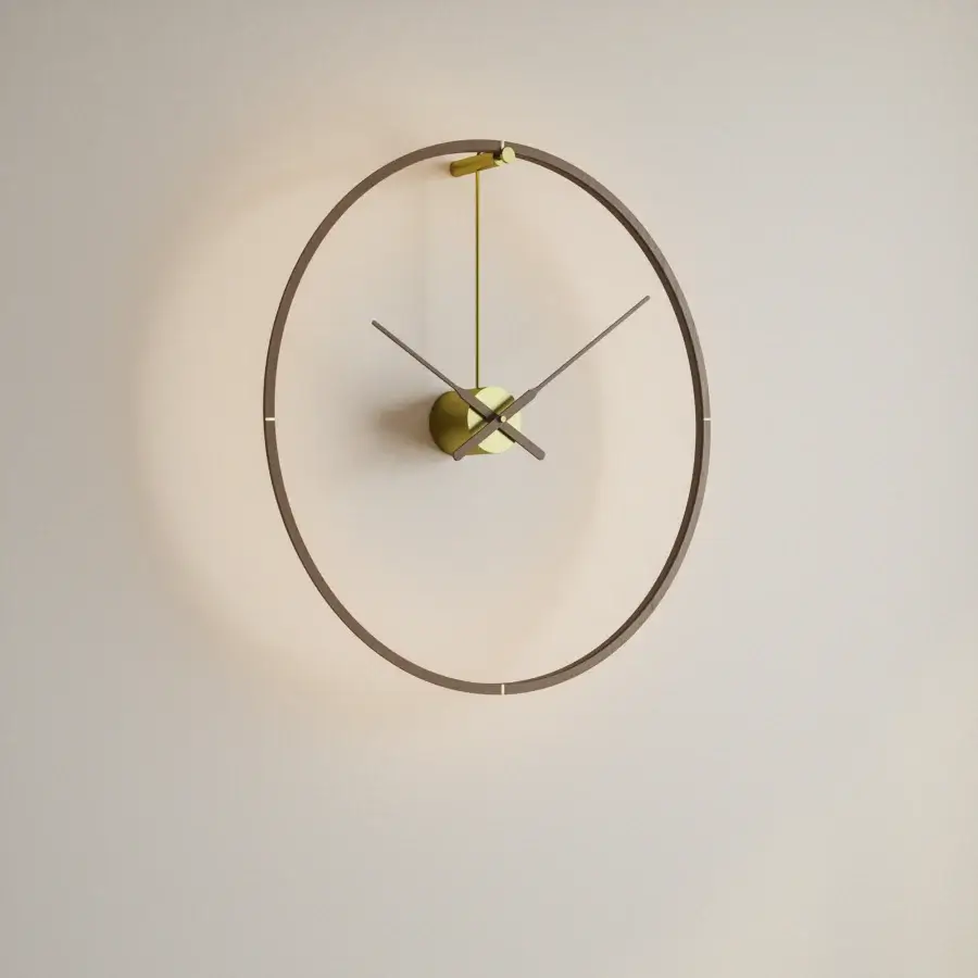 Exceptional Nomon Ombra Premium Clock Lamp wall-mounted in dark anodized metal with a warm gold clock face and integrated LED light