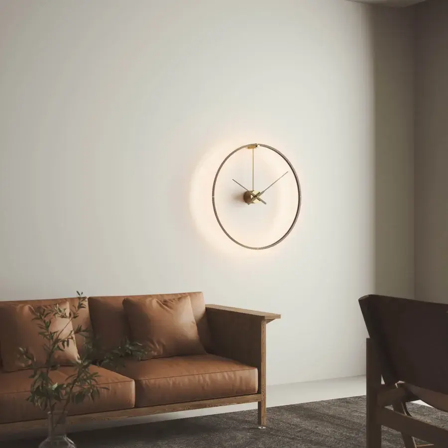 Superior Nomon Ombra Premium Clock Lamp wall-mounted in gold-toned metal with dark anodized detailing and satin finish