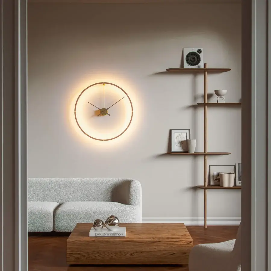 Distinguished Nomon Ombra Premium Clock Lamp wall-mounted in dark anodized metal with a balanced clock face and integrated LED light ring