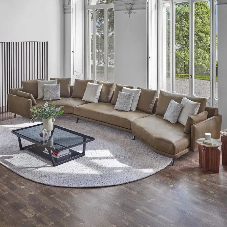 Exceptional Porada Étienne sofa with warm brown leather upholstery and pewter grey metal feet built with wooden inserts