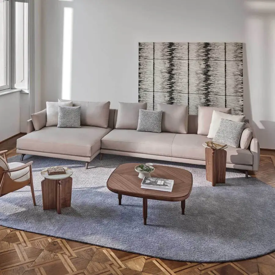 Superior Porada Étienne sofa with neutral beige Microflock upholstery and pewter grey metal built with wooden inserts