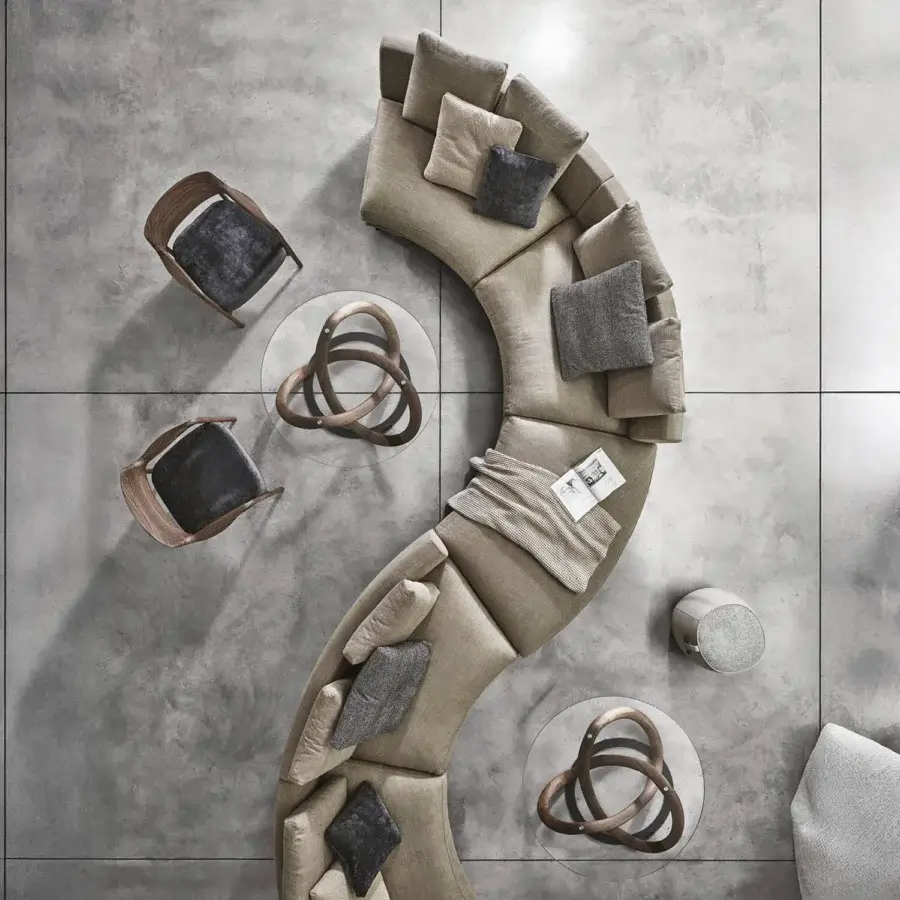 Distinguished Porada Étienne sofa with curved form and neutral beige Memory Foam Microflock upholstery supported by pewter grey metal feet