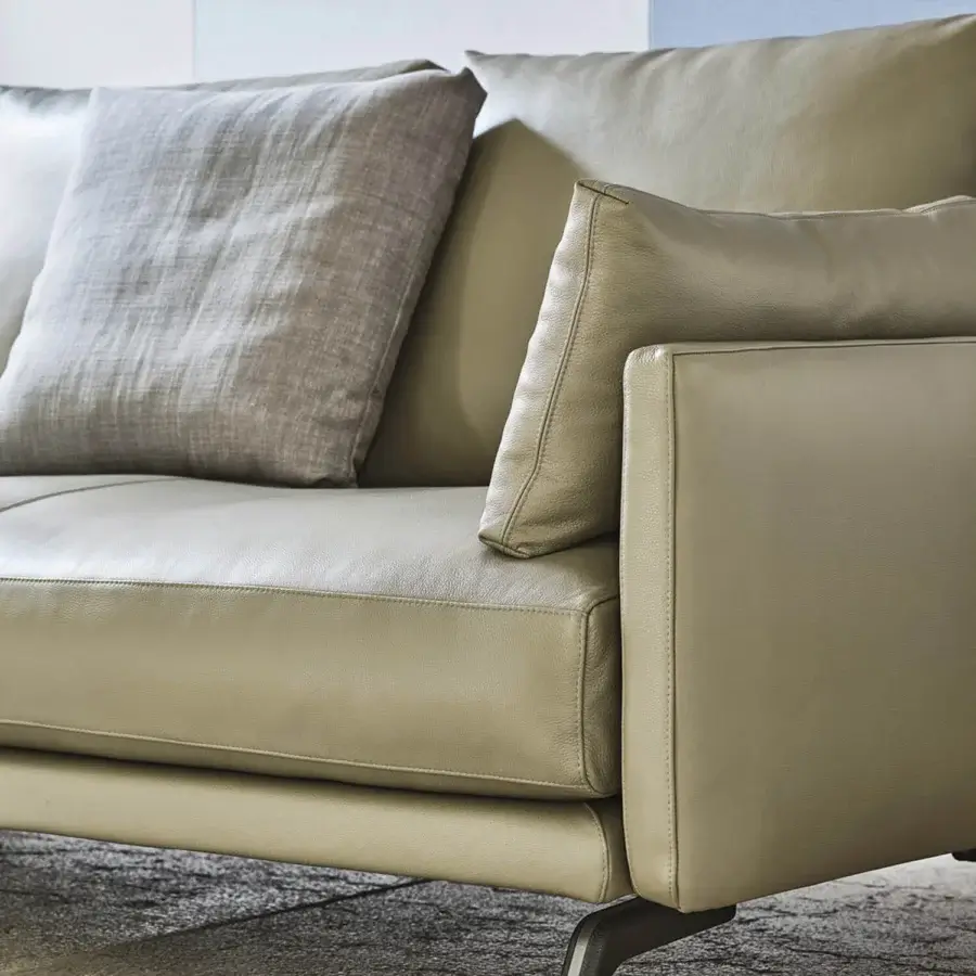 Superior Porada Étienne sofa with linear design upholstered in muted olive green leather and pewter grey metal feet