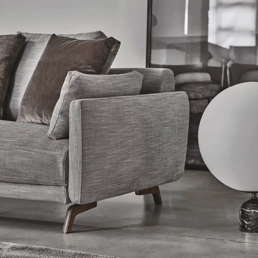 Distinguished Porada Étienne sofa with linear design upholstered in muted gray textile and decorative leather cushions with pewter grey metal feet