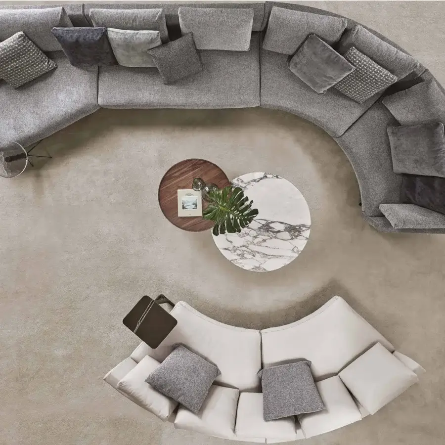 Exceptional Porada Étienne sofa with curved form upholstered in muted gray Microflock and supported by pewter grey metal with wooden inserts