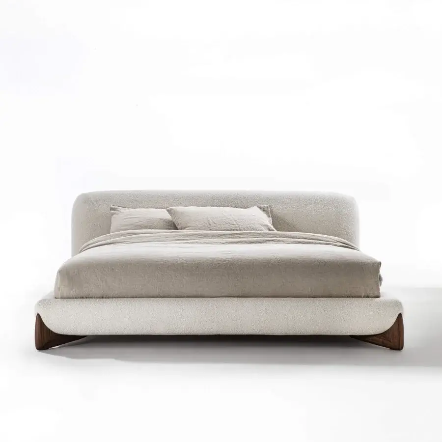 Superior Porada Softbay bed upholstered in textured beige textile with solid Canaletta walnut end-feet