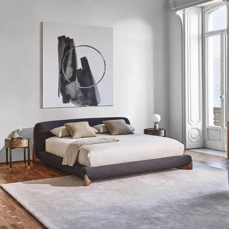Superior Porada Softbay bed crafted in dark gray woven fabric with satin Canaletta walnut wood end-feet