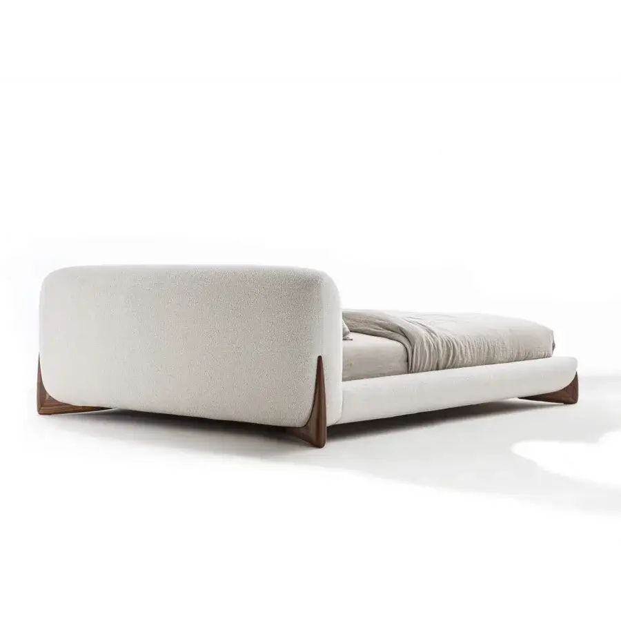 Captivating Porada Softbay bed upholstered in textured neutral beige bouclé fabric with solid Canaletta walnut wood end-feet