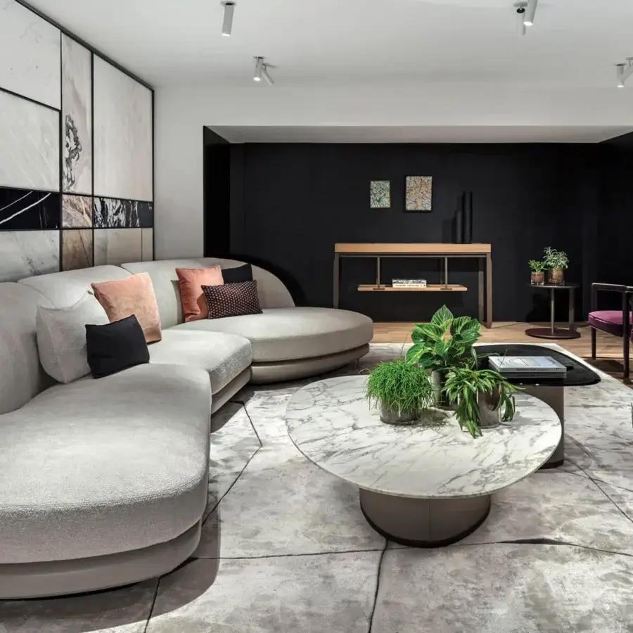 Elegant Giorgetti Galet coffee table with polished marble displaying grey and white veining and warm bronze finished metal support