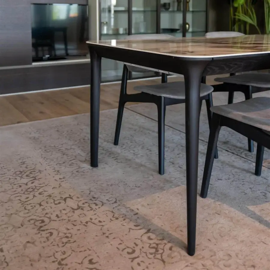 Elegant Dallagnese Smooth table with stone-like top displaying grey and beige veining and sleek dark-toned metal legs