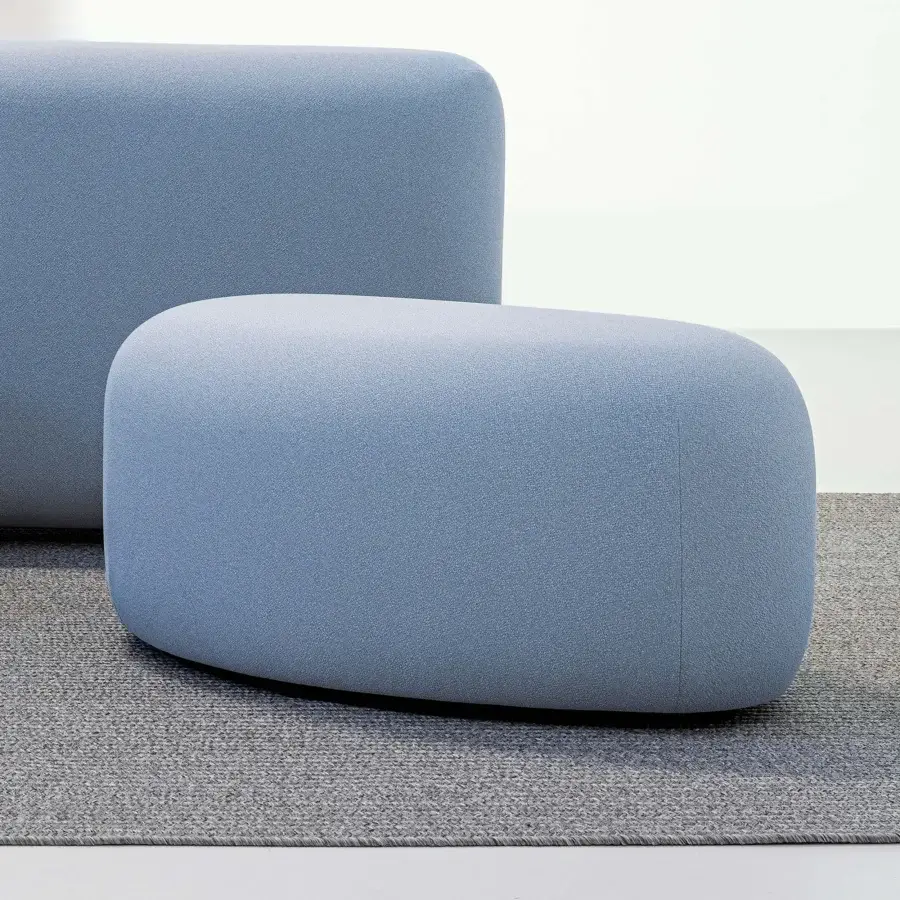 Superior LaCividina Lisse ottoman with smooth organic form upholstered in muted blue two-way stretch fabric and subtly textured finish