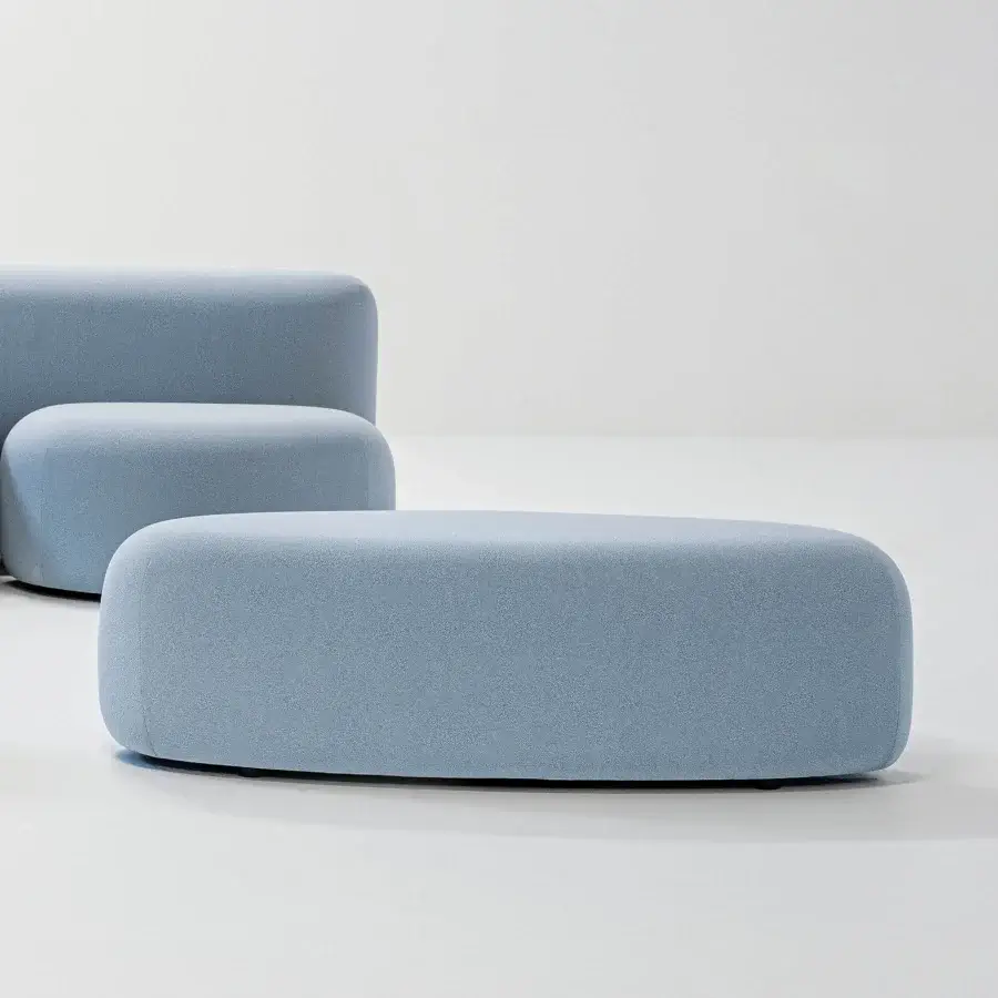 Distinguished LaCividina Lisse ottoman with uniquely smooth form upholstered in light blue two-way stretch fabric and textured finish