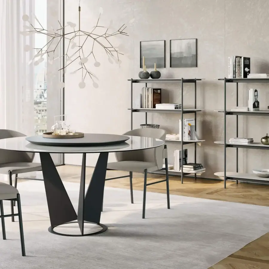 Elegant Dallagnese Eiffel round table with smooth glass top and matte dark gray V-shaped metal base