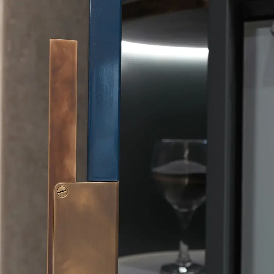 Elegant Visionnaire Siona bar cabinet with reflective dark finish and unique bronze-blue composite handle crafted in satin metal and veneered wood