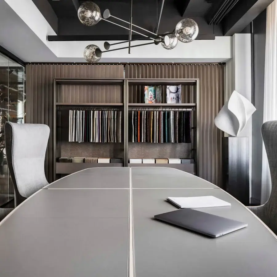 Superior Giorgetti Genius armchair with profiled steel backrest and medium gray fabric upholstery with bronze base