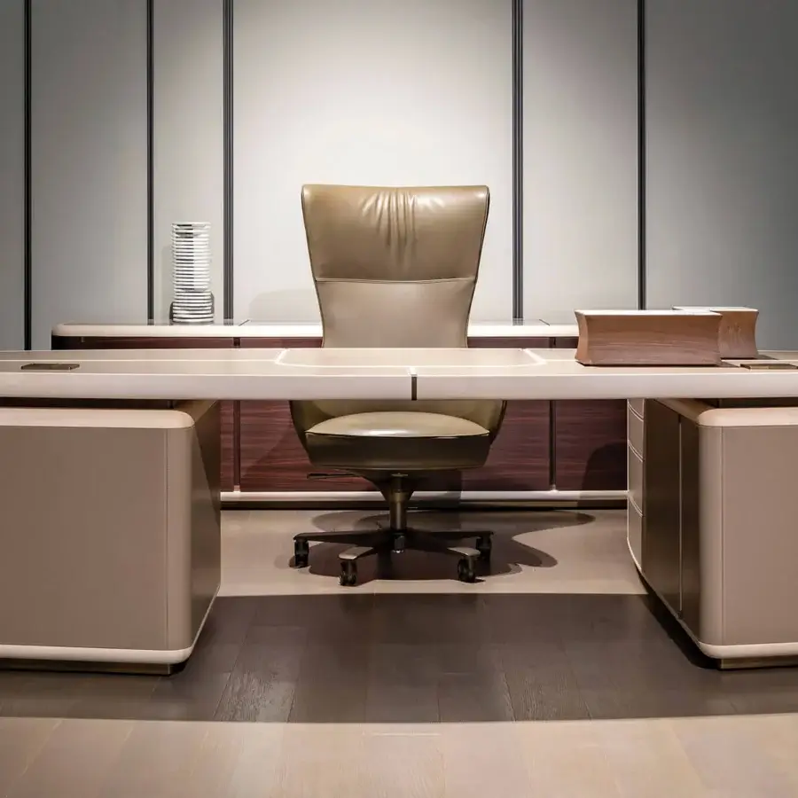 Exclusive Giorgetti Genius armchair with gently curved form and muted taupe textile upholstery in natural-effect bronze finish